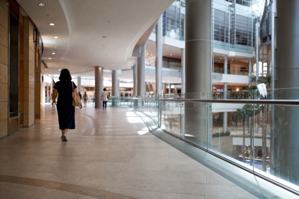 Interior of Suria KLCC mall walkway with directional signage, no text, no logos, no people