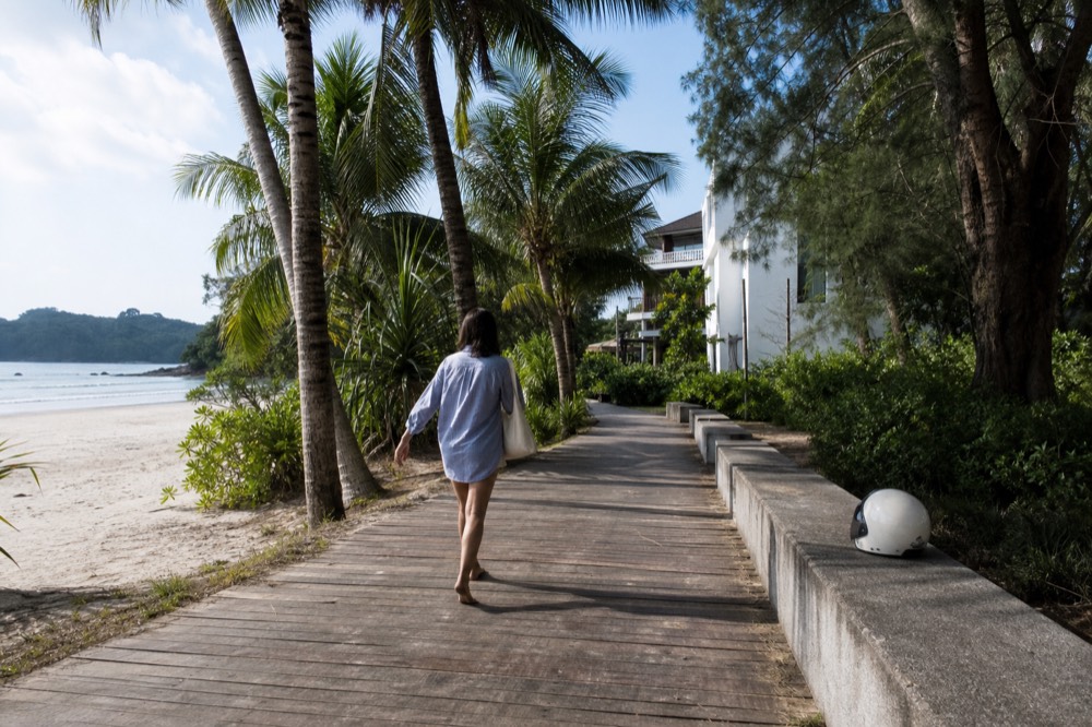 An island beachfront walkway near a low-rise attraction building, no text, no logos, no people