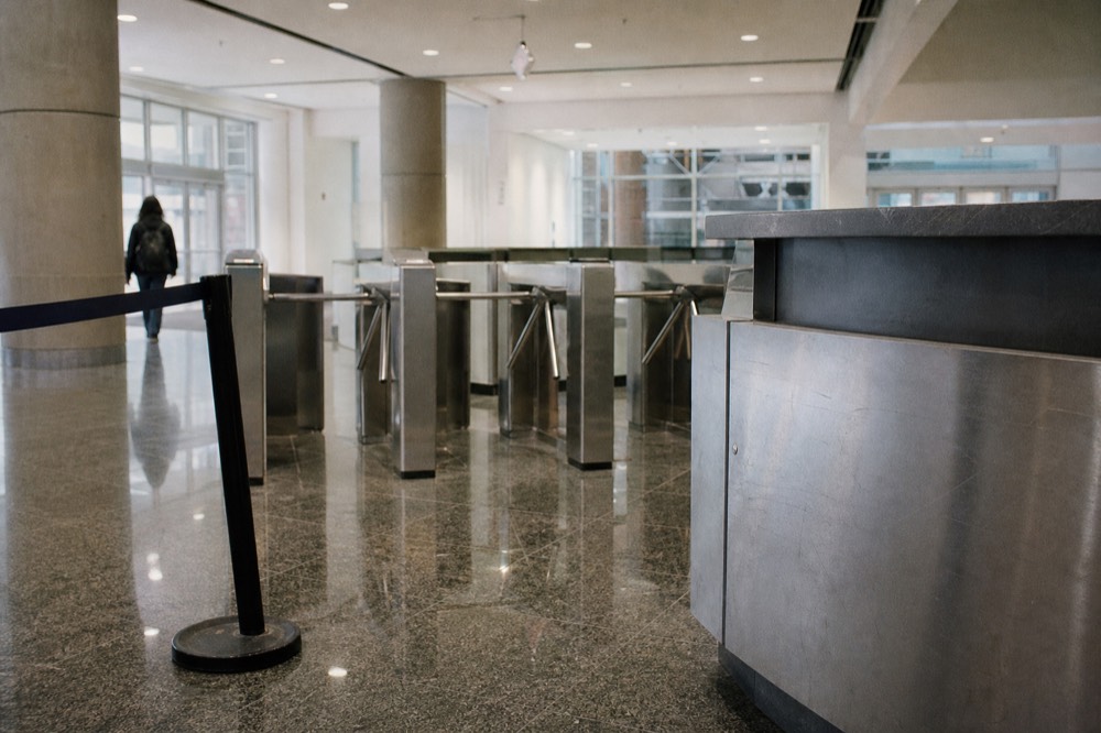A ticket counter and entry turnstiles at a modern aquarium entrance, no text, no logos, no people