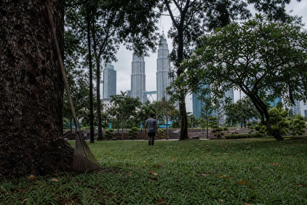 KLCC Park with Petronas Twin Towers in background, no text, no logos, no people